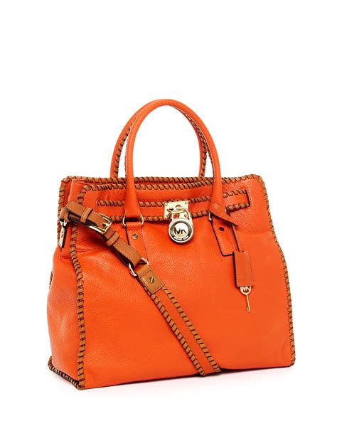 burnt orange michael kors purse.